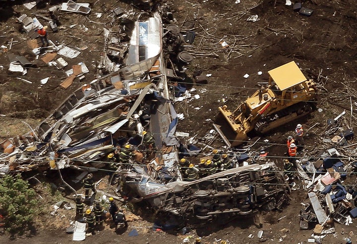 Investigators and first responders work near the wreckage of Amtrak 188 on May 13, 2015, in Philadelphia.