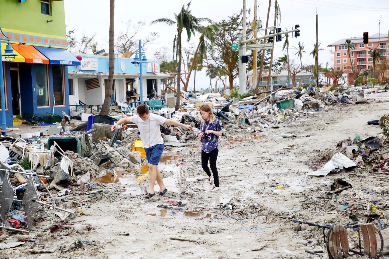 Jake Moses, 19, and Heather Jones, 18, of Fort Myers, explore a section of destroyed businesses at Fort Myers Beach on Sept. 29.