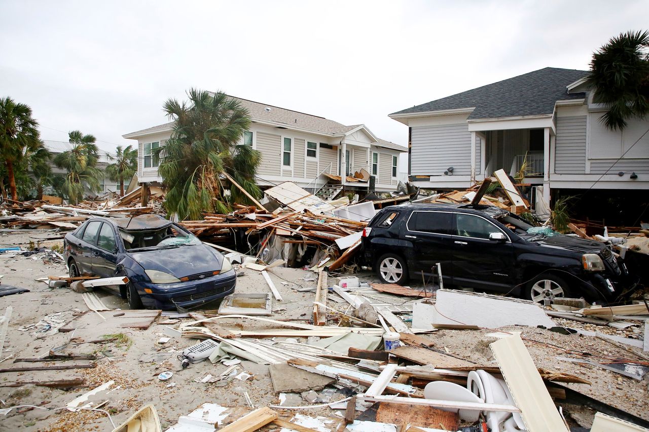 Remnants of damaged homes and flooded vehicles are seen in Fort Myers Beach on Sept. 29, 2022. 