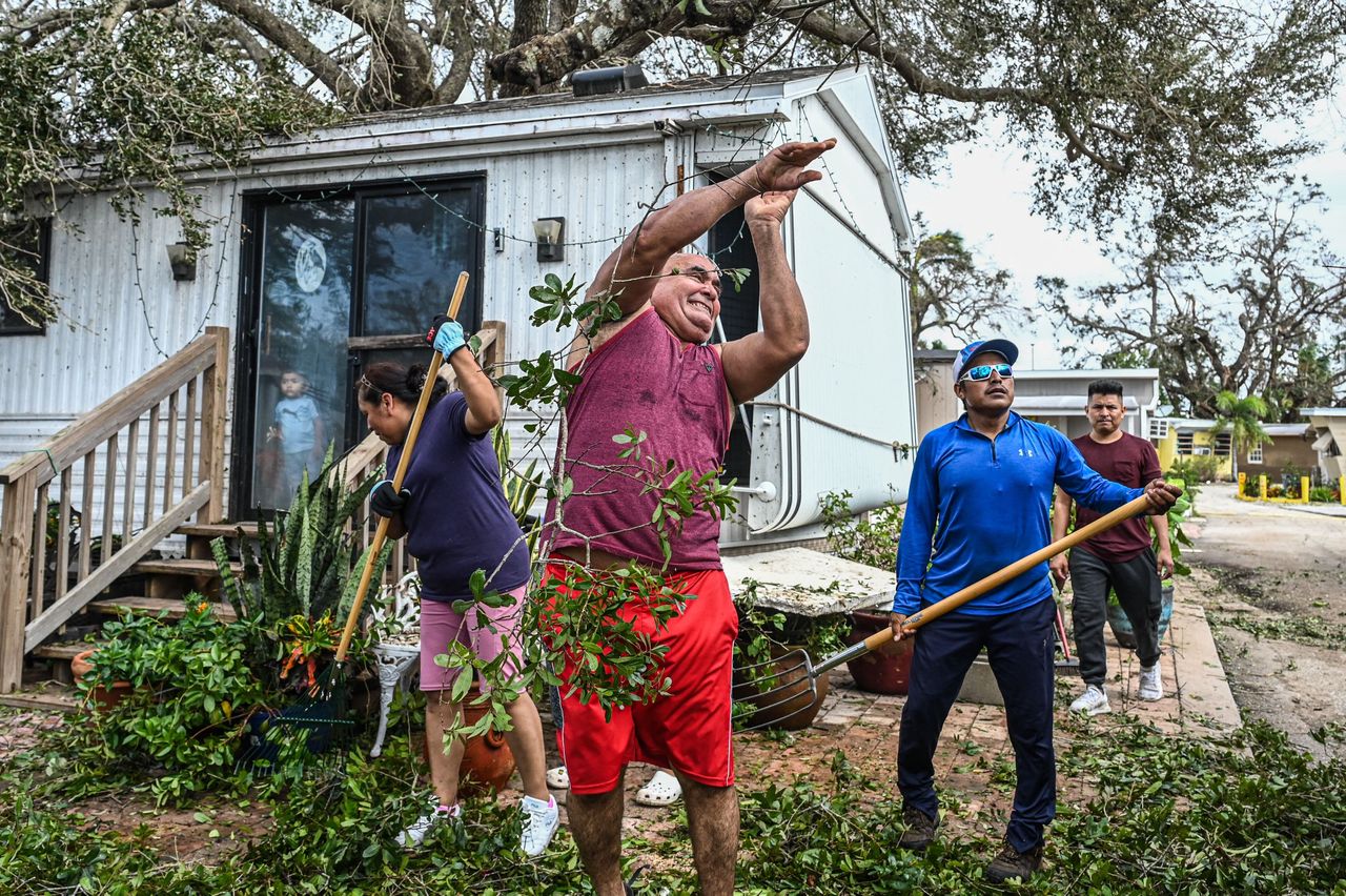 Residents of mobile homes clean up debris in the aftermath of Hurricane Ian, in Fort Myers on Sept. 29. 