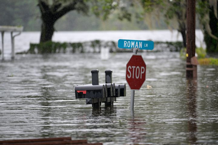 Mailboxes and a street sign are viewed in a flooded Orlando neighborhood in the aftermath of Hurricane Ian.