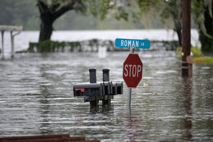 Mailboxes and a street sign are viewed in a flooded Orlando neighborhood in the aftermath of Hurricane Ian.