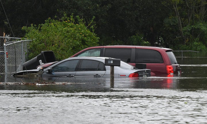 Cars are submerged in a flooded Orlando street in the aftermath of Hurricane Ian.