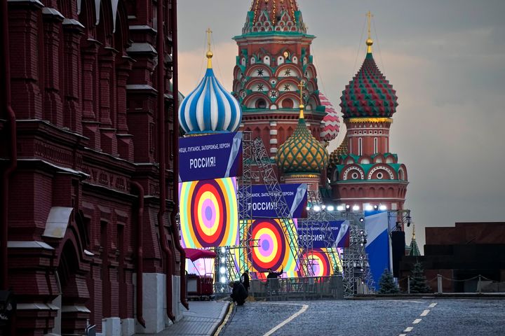 People make preparations for a concert at the Red Square, with constructions reading the words ''Donetsk, Luhansk, Zaporizhzhia, Kherson, Russia'', and the St. Basil's Cathedral and Lenin Mausoleum on the background, in Moscow, Russia, on Sept. 29, 2022. The Kremlin said that Russian President Vladimir Putin and the leaders of the four regions of Ukraine that held a referendum on joining Russia will attend a ceremony to sign documents on the regions' incorporation into Russia, which will be followed by a big concert on Red Square.