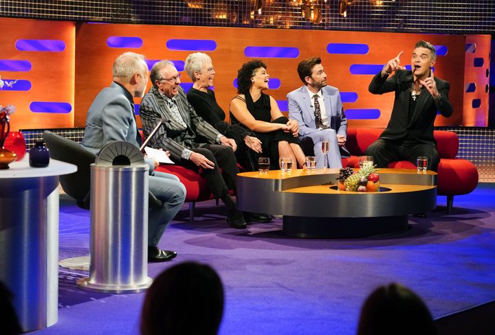 (L-R) Graham Norton, Eric Idle, Jamie Lee Curtis, Lydia West, David Tennant and Robbie Williams during the filming for the Graham Norton Show.