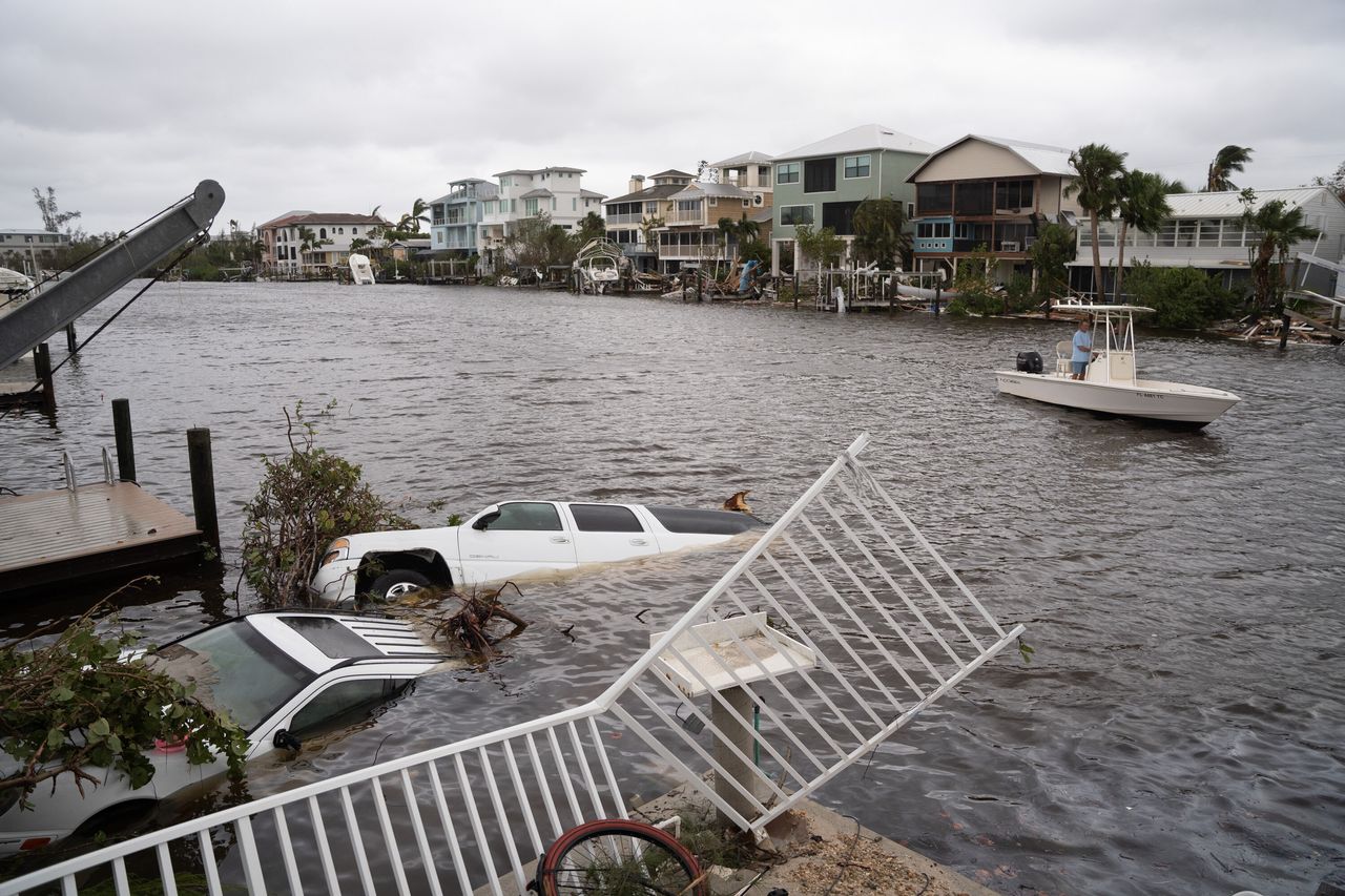Vehicles float in water September 29 after Hurricane Ian passed Bonita Springs, Florida.