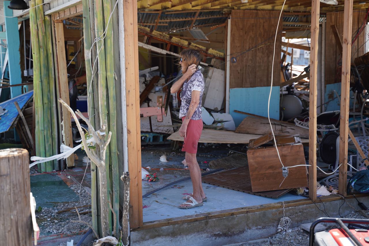 A woman stands in a destroyed building in Fort Myers Beach on September 29. 