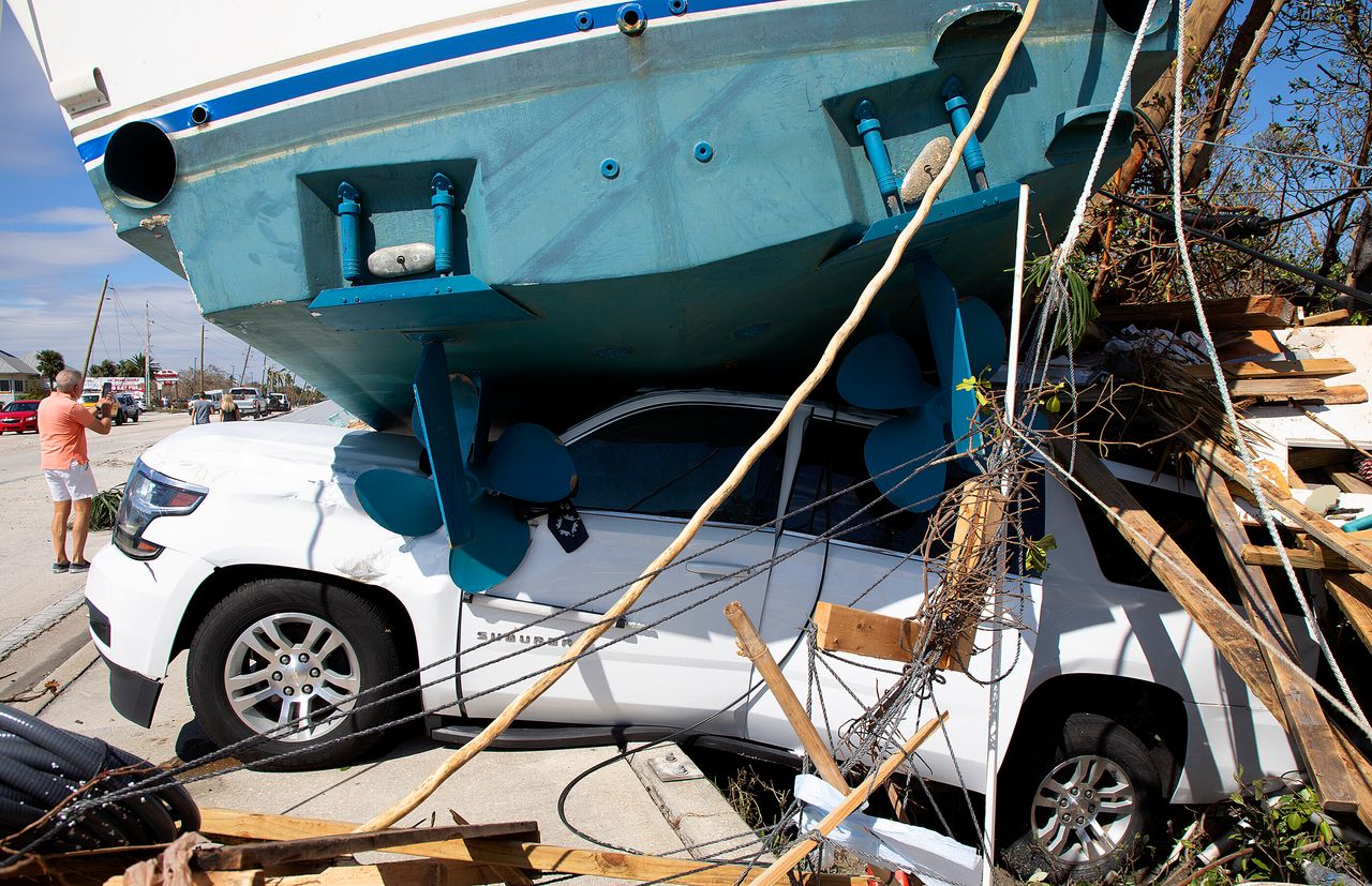 A large boat crushes a vehicle in Fort Myers Beach on Sept. 29, 2022. 