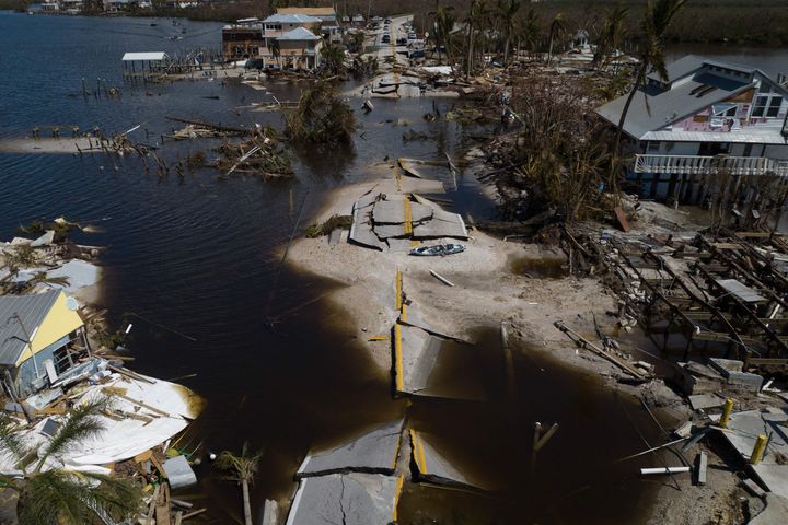 An aerial picture taken Saturday shows a broken section of the Pine Island Road, debris and destroyed houses in the aftermath of Hurricane Ian in Matlacha, Florida.