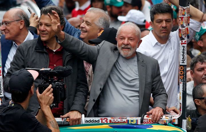 Brazil's former president and presidential candidate for the leftist Workers' Party , Luiz Inacio Lula da Silva (right), and Sao Paulo gubernatorial candidate Fernando Haddad (left) greet supporters during a campaign rally in Sao Paulo on Oct. 1, on the eve of the presidential election.