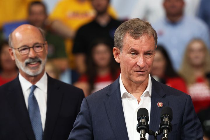 Cartwright (right) speaks before President Joe Biden takes the stage in Wilkes-Barre in late August. Pennsylvania Gov. Tom Wolf (left) looks on.