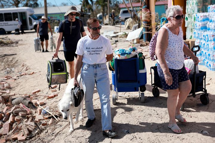 PINE ISLAND, FLORIDA - OCTOBER 02: Residents make their way to a boat to be evacuated from the island on October 2, 2022 in Pine Island, Florida.  Residents of the island are being urged to leave because the only road into the island is impassable and electricity and water remain out after Hurricane Ian passed through the area.