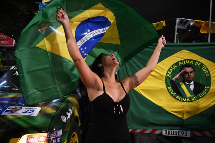 Una partidaria de Bolsonaro, enarbolando la bandera de Brasil.