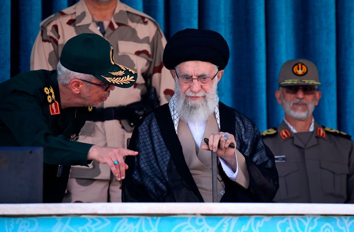 In this picture released by the official website of the office of the Iranian supreme leader, Supreme Leader Ayatollah Ali Khamenei, center, listens to chief of the General Staff of the Armed Forces Gen. Mohammad Hossein Bagheri at a graduation ceremony for a group of armed forces cadets at the police academy in Tehran, Iran, Monday, Oct. 3, 2022. Khamenei responded publicly on Monday to the biggest protests in Iran in years, breaking weeks of silence to condemn what he called “rioting” and accuse the U.S. and Israel of planning the protests.