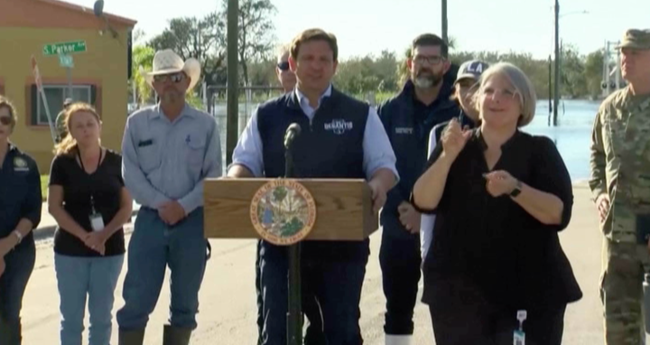 Florida Gov. Ron DeSantis wears branded campaign gear as he speaks Sunday at a press briefing about Hurricane Ian in Arcadia.