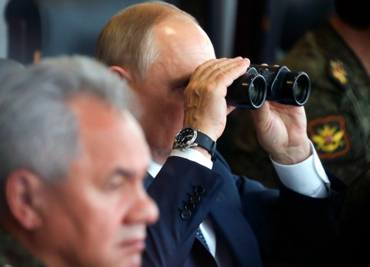 FILE - Russian President Vladimir Putin, center, watches through binoculars as Russian Defense Minister Sergei Shoigu sits near during the joint strategic exercise of the armed forces of the Russian Federation and the Republic of Belarus Zapad-2021 at the Mulino training ground in the Nizhny Novgorod region, Russia, on Sept. 13, 2021. Putin's threats to use "all the means at our disposal" to defend his country as it wages war in Ukraine have cranked up global fears that he might use his nuclear arsenal, with the world's largest stockpile of warheads. (Sergei Savostyanov, Sputnik, Kremlin Pool Photo via AP, File)