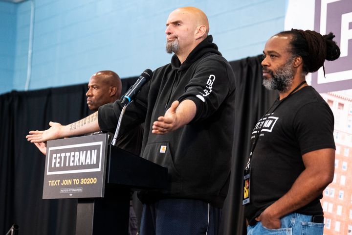 John Fetterman, Democratic nominee for Senate in Pennsylvania, appears on stage with Lee Horton, right, and his brother Dennis "Freedom" Horton at a rally in Philadelphia on Sept. 24.
