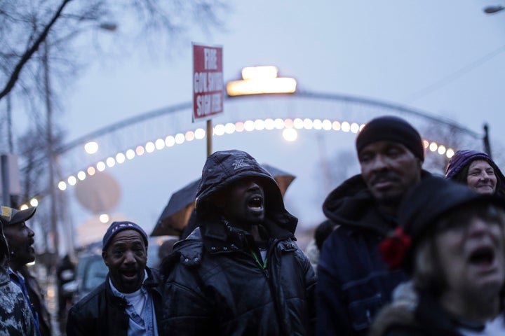 In a Friday Jan. 8, 2016, photo, Flint residents shout while protesting outside of Flint City Hall against Gov.Rick Snyder in Flint, Mich.