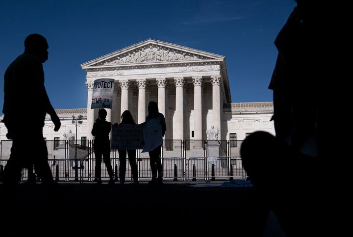 A small group of abortion-rights supporters gather in front of the Supreme Court on June 28 in Washington.