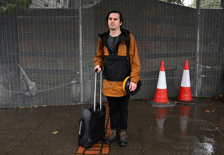 EPA photographer Tolga Akmen poses for a photograph outside the perimeter fence of the International Convention Centre.