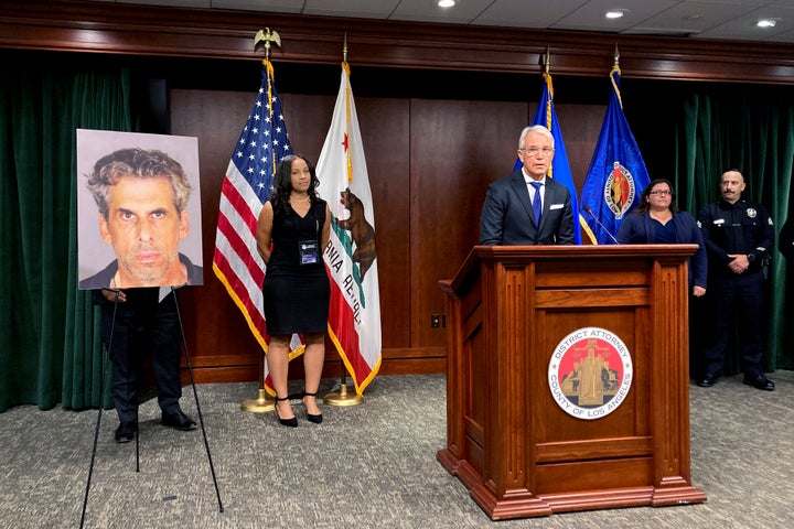 Los Angeles District Attorney George Gascon, at podium stands by a photo of TV producer Eric Weinberg during a news conference to announce sexual assault charges against him on Wednesday.