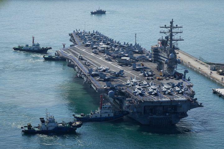 The U.S. carrier USS Ronald Reagan is escorted as it arrives in Busan, South Korea on Sept. 23, 2022. 