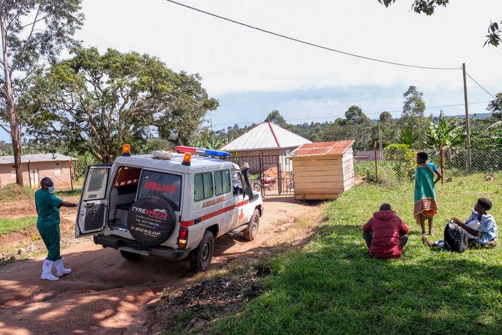 A medical officer from the Uganda Red Cross Society instructs people with suspected Ebola symptoms to enter an ambulance, in Madudu, near Mubende, in Uganda, Thursday, Sept. 29, 2022. (AP Photo/Hajarah Nalwadda)