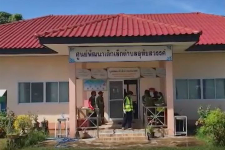 In this image taken from video, officials enter the site of an attack at a daycare center, Thursday, Oct. 6, 2022, in the town of Nongbua Lamphu, north eastern Thailand.