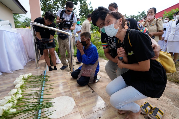 Relatives mourn during a ceremony for those killed in the attack on the Young Children's Development Center.