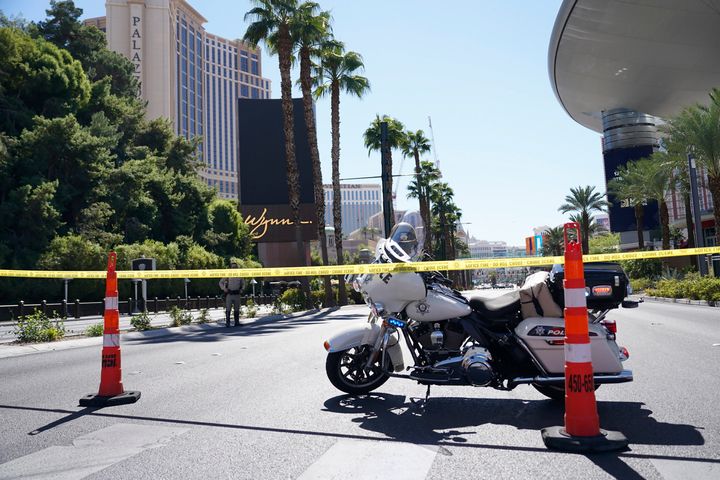 Police tape blocks off a road near where multiple people were stabbed in front of a Strip casino in Las Vegas, on Oct. 6, 2022. Police say an attacker has killed two people and wounded six others in stabbings along the Las Vegas Strip.