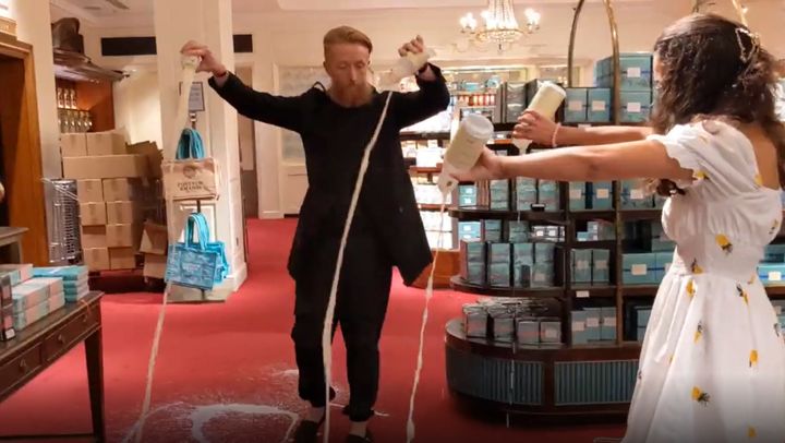 Grab from video issued by Animal Rebellion of supporters of Animal Rebellion pouring out milk in Fortnum & Mason in London.