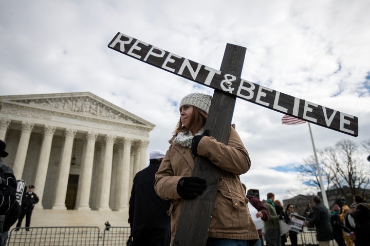 An anti-abortion advocate holds a cross outside of the Supreme Court during the March for Life, Jan. 27, 2017, in Washington, D.C.