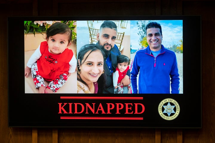 Images are displayed of 8-month-old Aroohi Dheri, left, with her mother Jasleen Kaur, her father Jasdeep Singh, and her uncle Amandeep Singh, at a news conference in Merced, Calif., on Wednesday, Oct. 5, 2022. Sheriff Vern Warnke, of Merced County, announced Wednesday that the family members, who were kidnapped at gunpoint from their trucking business in central California, have been found dead. (Andrew Kuhn/The Merced Sun-Star via AP)