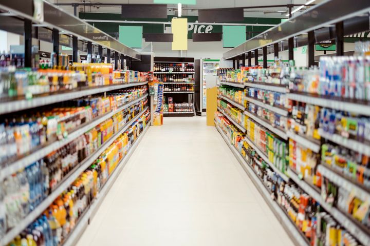 Supermarket aisle with shelfs full of a variety of products