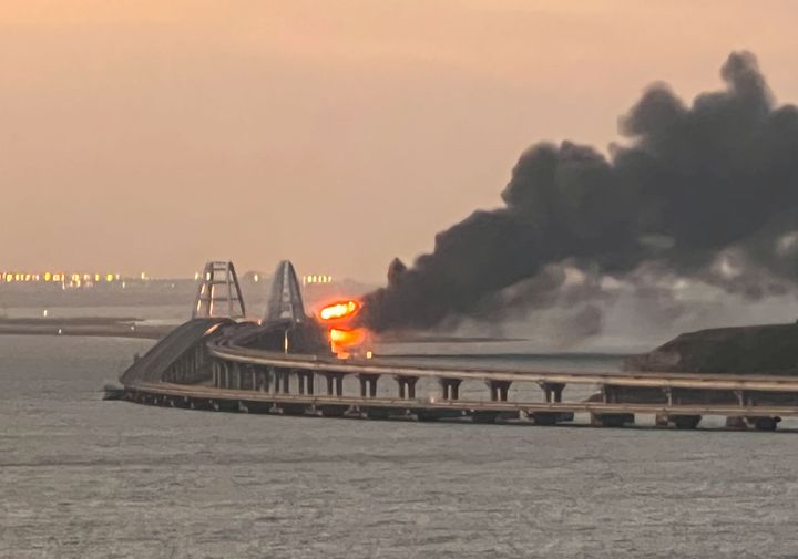 A view shows a fire on the Kerch bridge at sunrise in the Kerch Strait, Crimea.