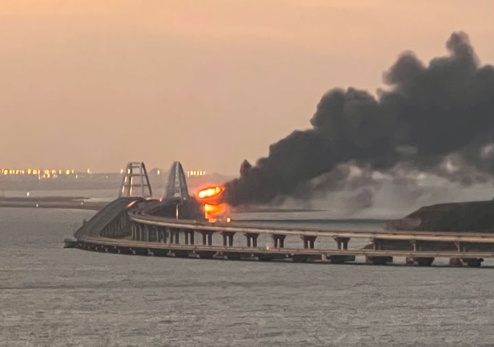 A view shows a fire on the Kerch bridge at sunrise in the Kerch Strait, Crimea.