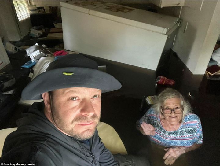 In this photo provided by Johnny Lauder, Lauder takes a selfie with his mother, Karen Lauder, 86, as he came to rescue her after water flooded her home, in Naples, Fla., Wednesday, Sept. 28, 2022, following Hurricane Ian. (Johnny Lauder via AP)