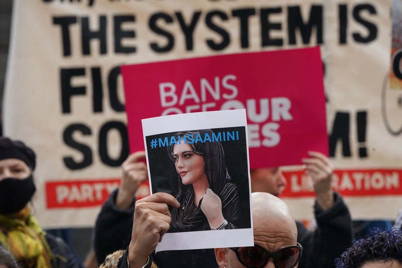 A demonstrator in New York City holds up a photo of Mahsa Amini in solidarity with protesters in Iran fighting for women's rights. The 22-year-old Amini was killed in the custody of Iran's religious police for improperly wearing her headscarf. Her death in mid-September has sparked weeks of heated protests. 