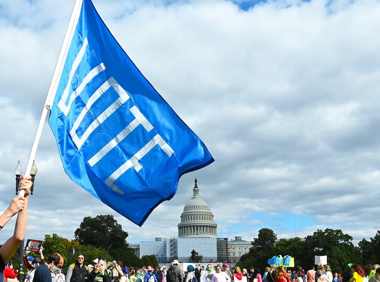 A "VOTE" sign appears outside the U.S. Capitol.