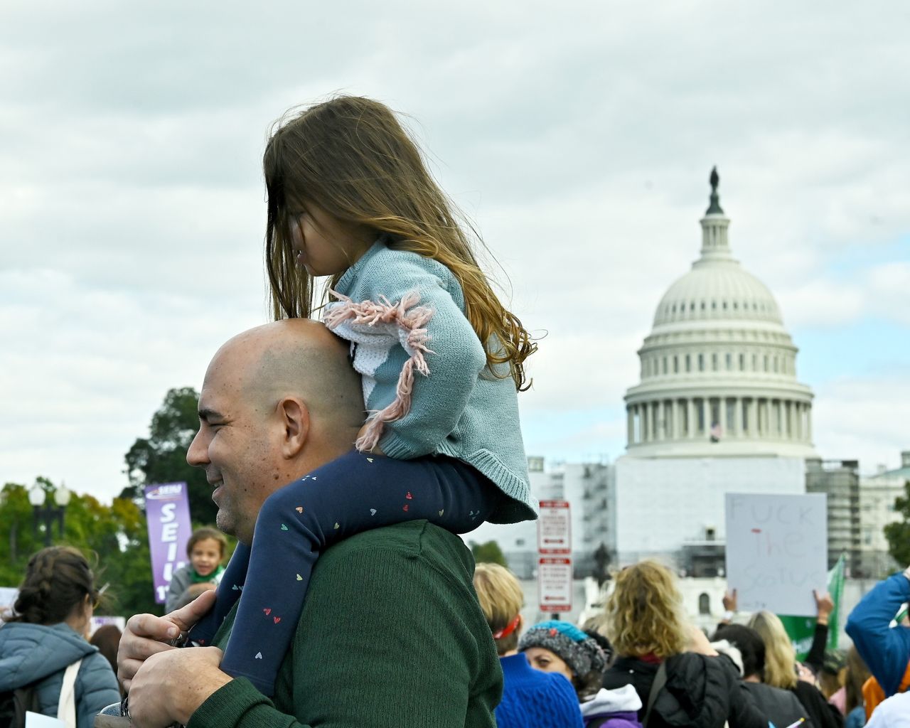 A young girl surveys the crowd from up high in Washington, D.C.