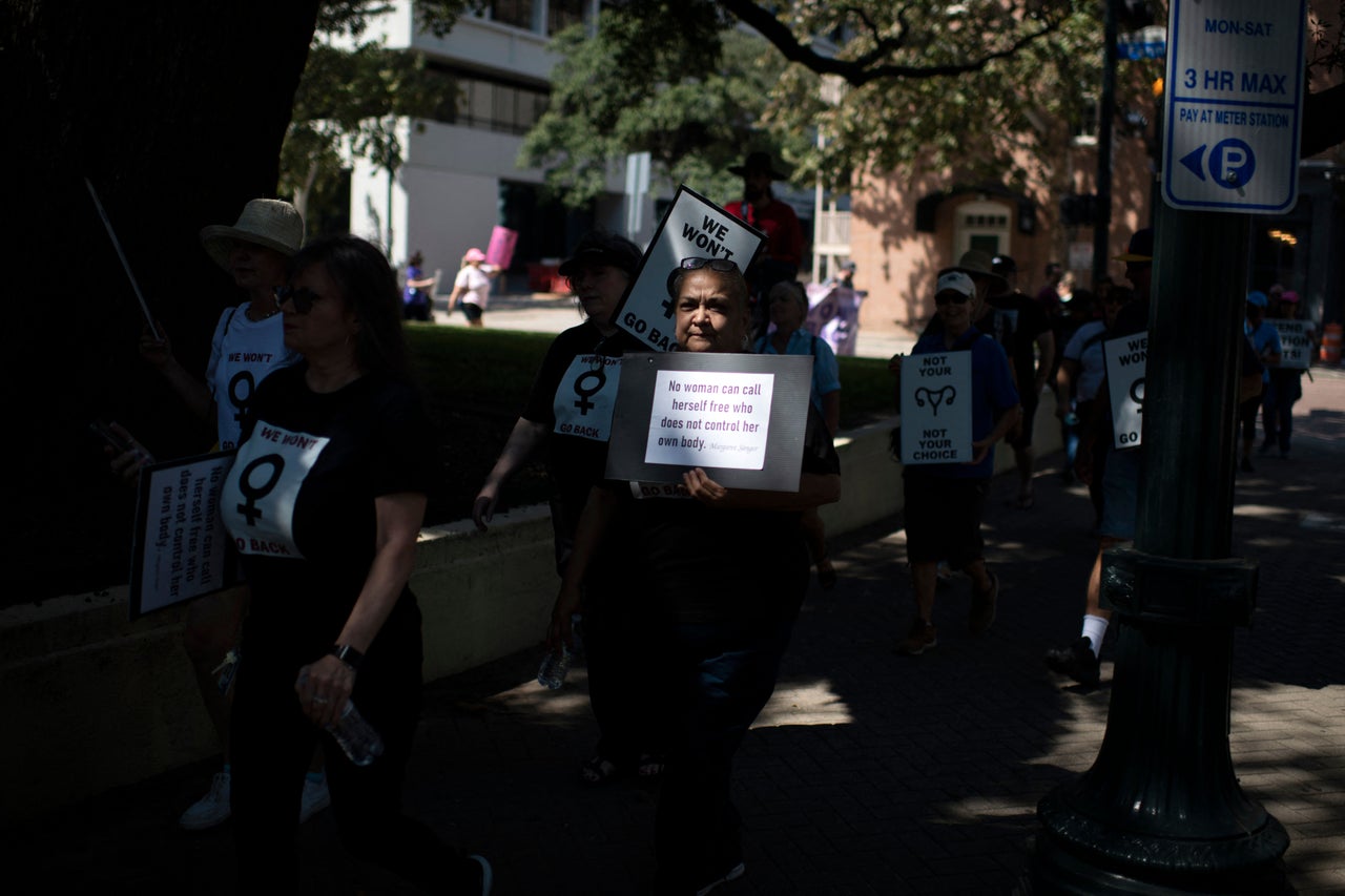 A Texas protester holds a sign with the Margaret Sanger quote, "No woman can call herself free who does not control her own body."