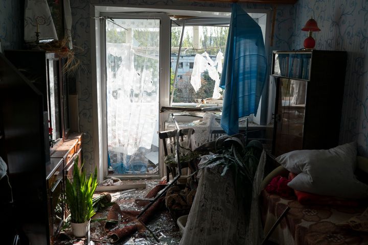 Debris cover the a room of Tetyana Lazunko's apartment that was damaged after a Russian attack at a residential area in Zaporizhzhia, Ukraine, Sunday, Oct. 9, 2022. (AP Photo/Leo Correa)