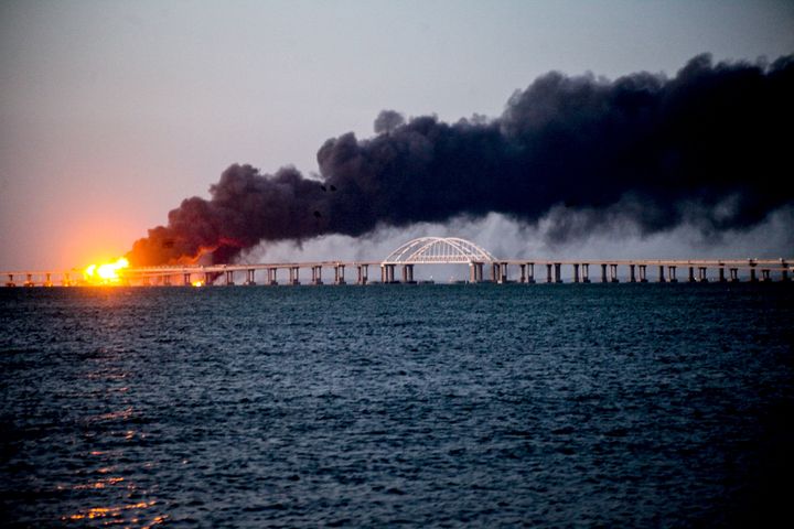 Explosion causes fire at the Kerch bridge in the Kerch Strait, Crimea on October 08, 2022. A fire broke out early Saturday morning on the Kerch Bridge -- preceded by an explosion -- causing suspension of traffic and bringing bus and train services to a halt. Three people were killed on Saturday in a "truck bombing" at a strategic bridge in Crimea, Russian investigators said.