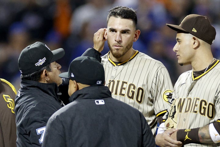 NEW YORK, NEW YORK - OCTOBER 09: Umpire Alfonso Marquez checks the ear of Joe Musgrove #44 of the San Diego Padres during the sixth inning against the New York Mets in game three of the National League Wild Card Series at Citi Field on October 09, 2022 in the Flushing neighborhood of the Queens borough of New York City. (Photo by Sarah Stier/Getty Images)