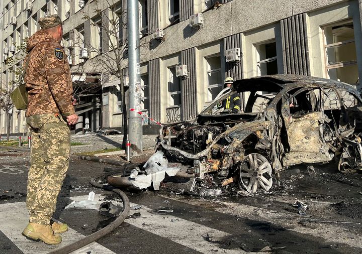 Rescue workers survey the scene of a Russian attack on Kyiv, Ukraine on Oct. 10, 2022. Two explosions rocked Kyiv early Monday following months of relative calm in the Ukrainian capital. 