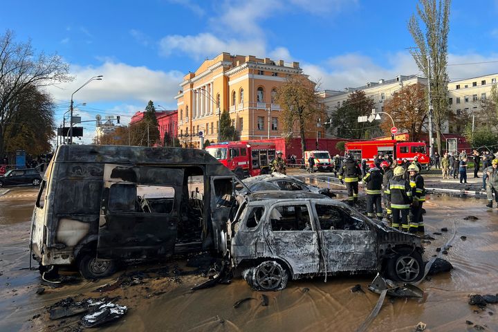 Rescue workers survey the scene of a Russian attack on Kyiv, Ukraine on Monday, Oct. 10, 2022. 