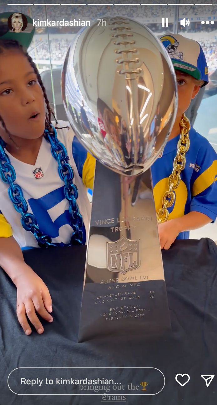 Saint and a friend check out the Rams' Vince Lombardi Trophy for winning the Super Bowl.