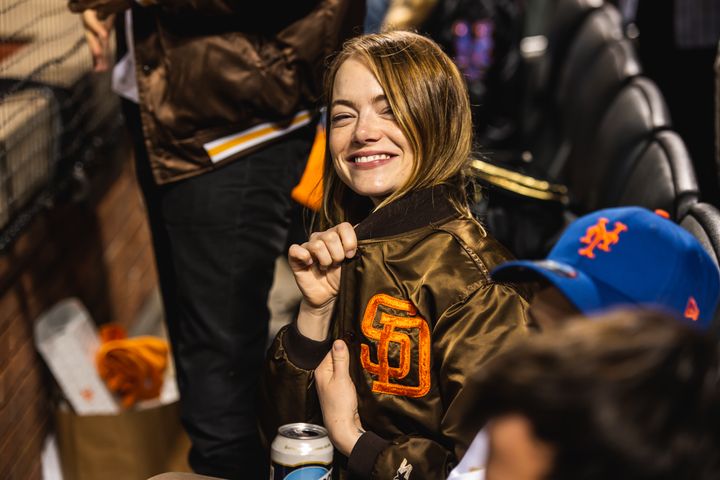 Emma Stone poses for a photo as the San Diego Padres play against the New York Mets in Game One of the Wild Card Series at Citi Field on Oct. 7, in New York.