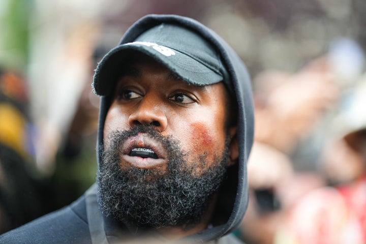 Kanye West is seen wearing a Balenciaga boxing mouthguard, outside Givenchy, during Paris Fashion Week.