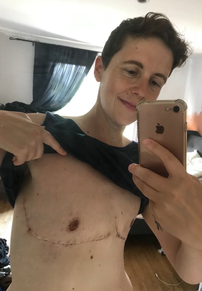 "Every day, before I hop into the shower, I look at myself in the mirror and smile," writes Jaime Lazich, pictured in their apartment after top surgery.
